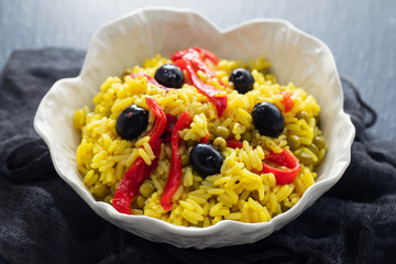 rice with vegetables and black olives in beautiful dish