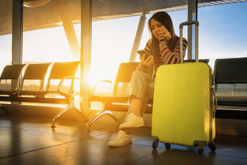 Fototapeta na wymiar Travel. Woman with suitcase. Airport waiting lounge.