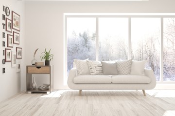 Stylish room in white color with sofa and winter landscape in window. Scandinavian interior design. 3D illustration