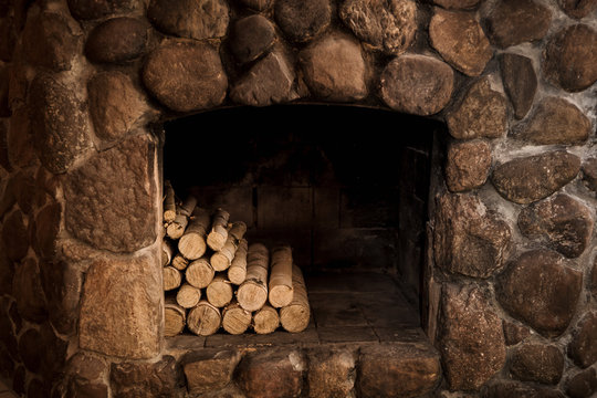 stone fireplace with hearth and logs