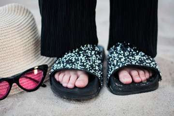 child legs flip flops shoes hat sand bling suit glasses child's hand