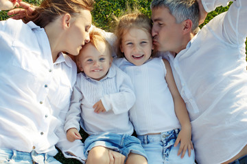 Family in nature. Parents with children have fun playing. 