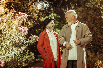 Cheerful senior couple talking during their stroll.