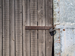 rusty lock hanging on old gate