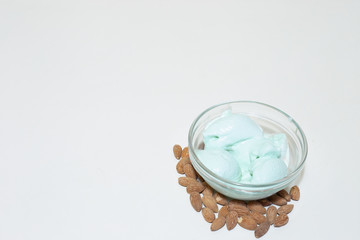 Green almond ice cream on white background with copy space – Nut flavored homemade desert – Healthy and sweet frozen snack for summer