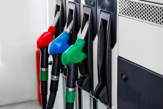Gas pump nozzles in service station. Colorful Petrol pump filling nozzles, Gas station in a service.
