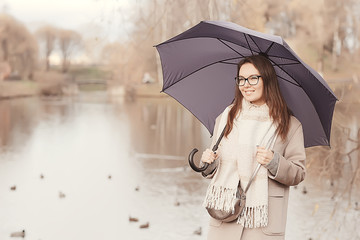 Fototapeta premium long background girl umbrella / horizontal view rainy autumn day young woman with umbrella