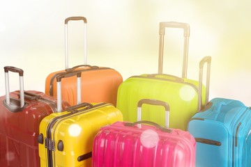Many multi-colored big suitcases on a gold background