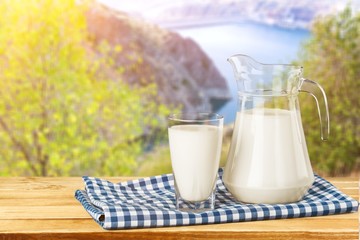 Glass of milk and bottle on  background