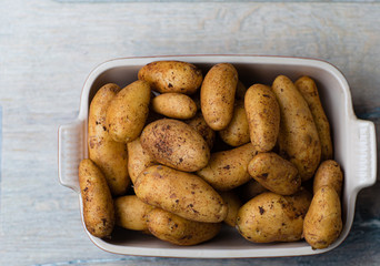 A new crop of potatoes lies in a baking dish.