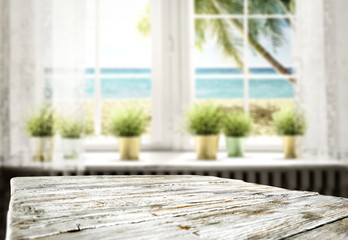 Table background with a beautiful ocean sunny window view