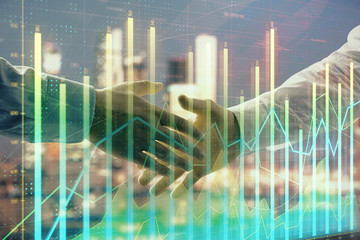 Double exposure of financial chart on cityscape background with two businessmen handshake. Concept of financial analysis and investment opportunities