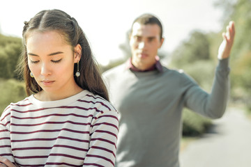Fototapeta premium Angry man actively gesturing while arguing with girlfriend