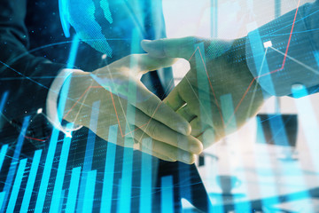 Multi exposure of financial chart and map on office background with two businessmen handshake. Concept of success in business