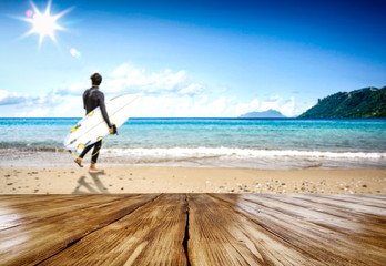 Wooden table background at the sunny beach seashore 