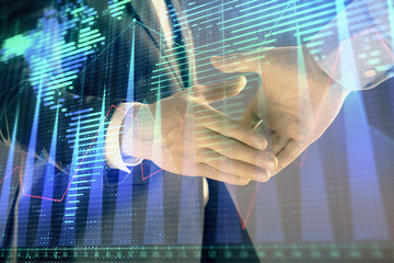 Naklejka na ściany i meble Multi exposure of forex graph and world map on abstract background with two businessmen handshake. Concept of success on international markets