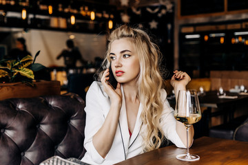 Beautiful woman talking on the phone in a restaurant