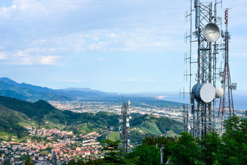 Aerial view of a telecommunication tower, satellite dish, network repeaters, base transceiver....
