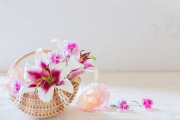 Fototapeta na wymiar summer flowers in basket on white background