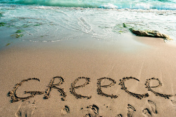 inscription on the sand Greece, sea water