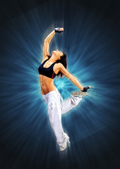 Young beautiful athletic woman jumping dancing modern style dance hip-hop on studio on wall...