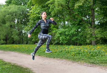 Fototapeta na wymiar girl running in the Park, runner