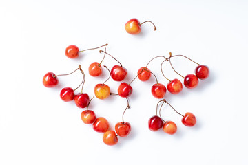 Top view image of fresh ripe red cherries isolated on white background