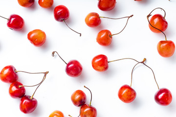 Top view image of fresh ripe red cherries isolated on white background