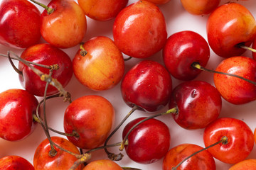 Top view closeup image of fresh ripe red cherries isolated on white background