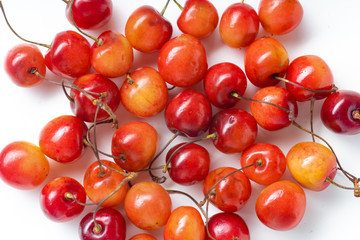 Top view closeup image of fresh ripe red cherries isolated on white background