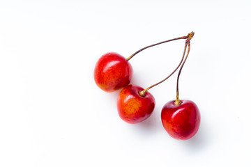 Top view image of bucnhes of fresh ripe red cherries isolated on white background