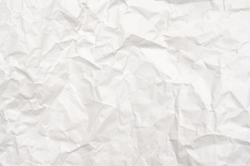 Modern crumpled white paper on empty sheet gray background with light shadows for creative wallpaper, card, art work design.