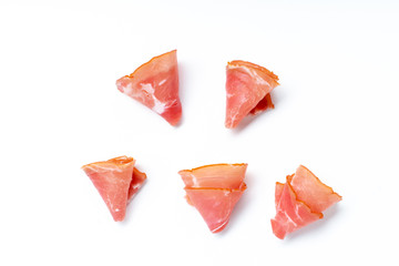 Thin ham slices isolated on white background. Snack idea