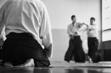 Aikido training. Black and white image. The teacher shows reception.  Traditional form of clothing...