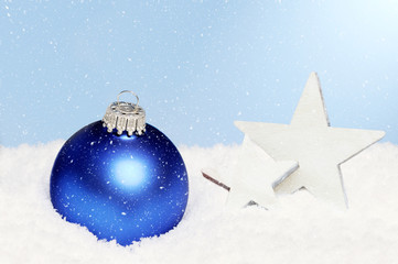  blue christmas ornament lying in snow © Caro