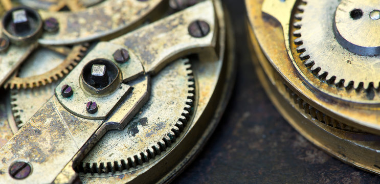Gears of a vintage metal business clock watch close-up, time mechanism banner with copy space