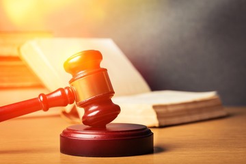 Wooden gavel with book close up