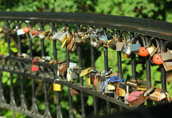 Bridge with many colorful padlocks as the symbol of eternal love 