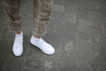White Sneaker shoes standing on street. Side view