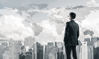 Concept of business success and control with confident boss against cityscape background