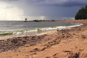 Silhouette of a couple on the coast of the Gulf of Finland