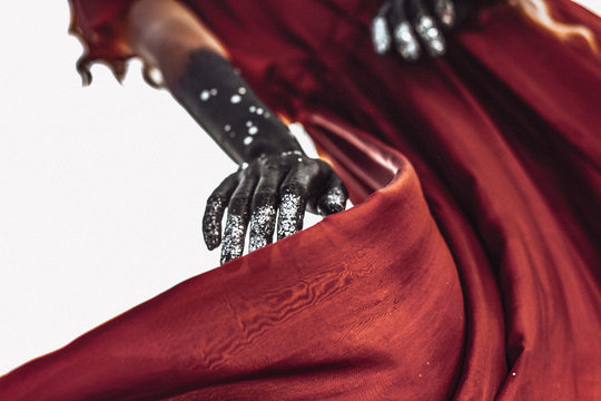 close up of woman hands painted black conceptual image