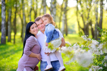 Fototapeta premium people concept. friendly family walks in a beautiful summer park.