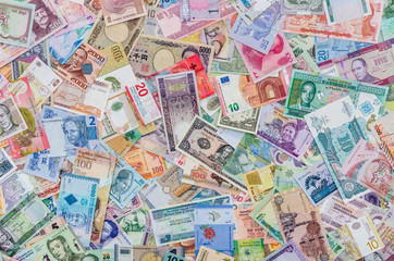 World money collection of different countries as background