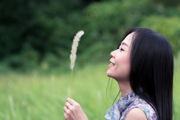 Freedom happy girl looking grass on the meadow field