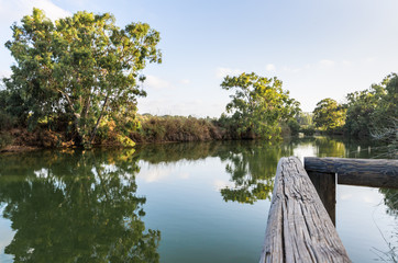 Panoramic  view at the setting sun on the remains of a wooden pier on the bank of the Alexander river, near Kfar Vitkin settlement in northern Israel