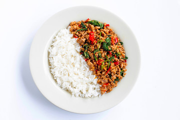 Rice with stir-fried hot and spicy pork with holy basil on white.