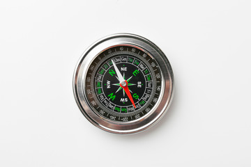 Close up of a compass on a white background
