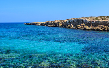 Fototapeta na wymiar Azure Lagoon on the island of Cyprus. Mediterranean coastline. Background. Copy space.