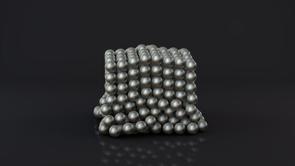 3D rendering of a neocube, a geometric figure consisting of many chrome-plated magnetic metal balls. The neocube is destroyed on a dark reflective surface. Futuristic abstract 3D design. 3D rendering.